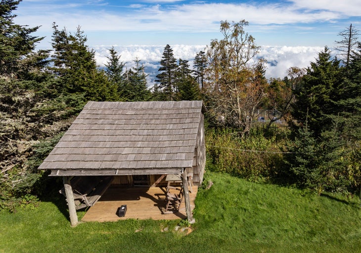 Cabin deck with a rocking chair and swing at LeConte Lodge